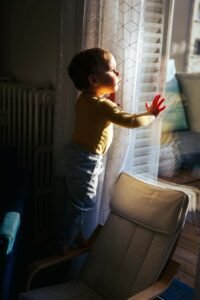 Photo d'enfant qui regarde à la fenêtre